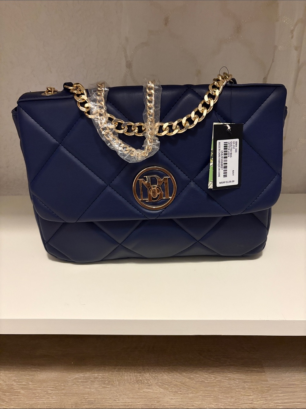 Quilted Navy Crossbody with Gold Chain and Logo Medallion